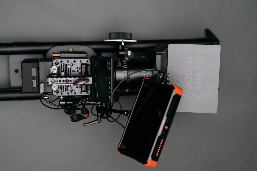 Flat lay of field reporting equipment including microphone, recorder, and cables