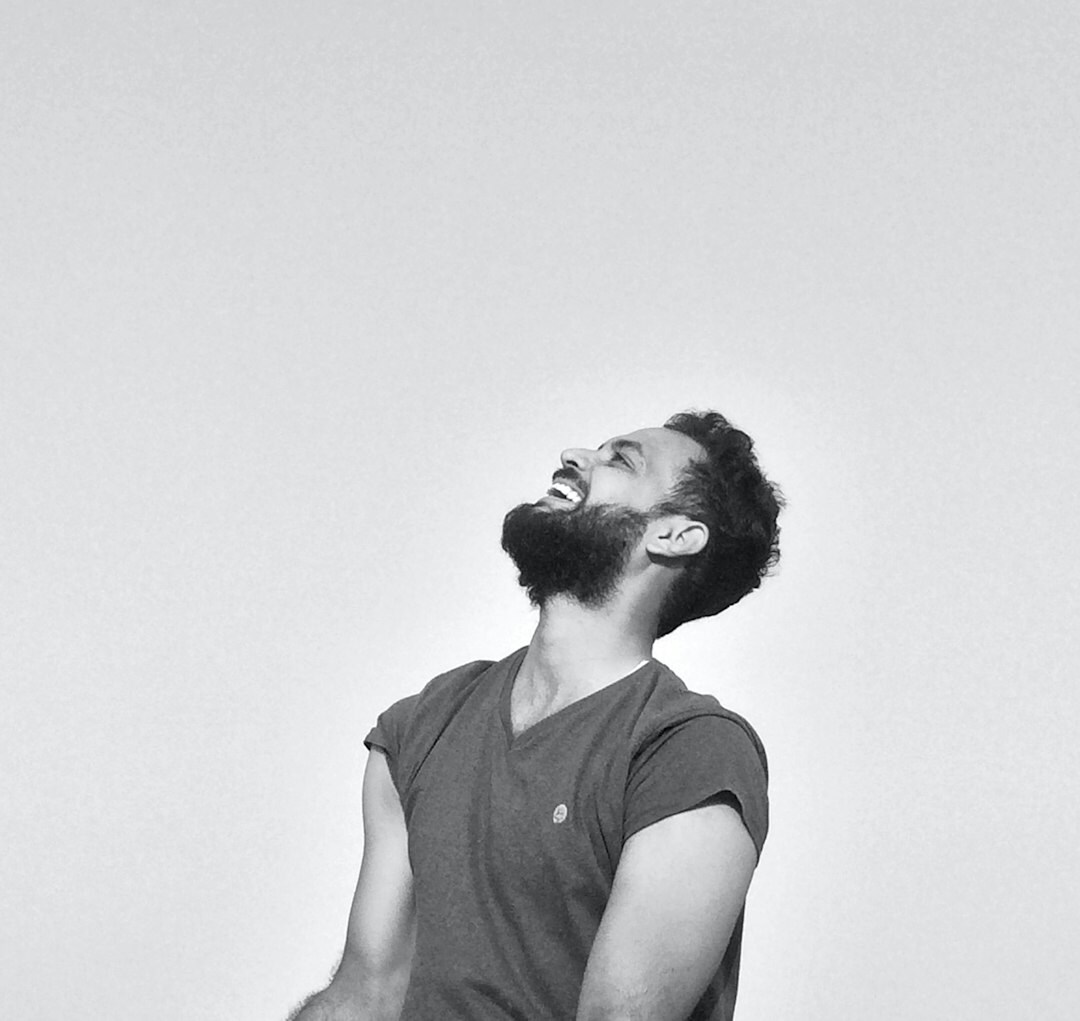 Studio portrait of a man with short dark hair and a beard